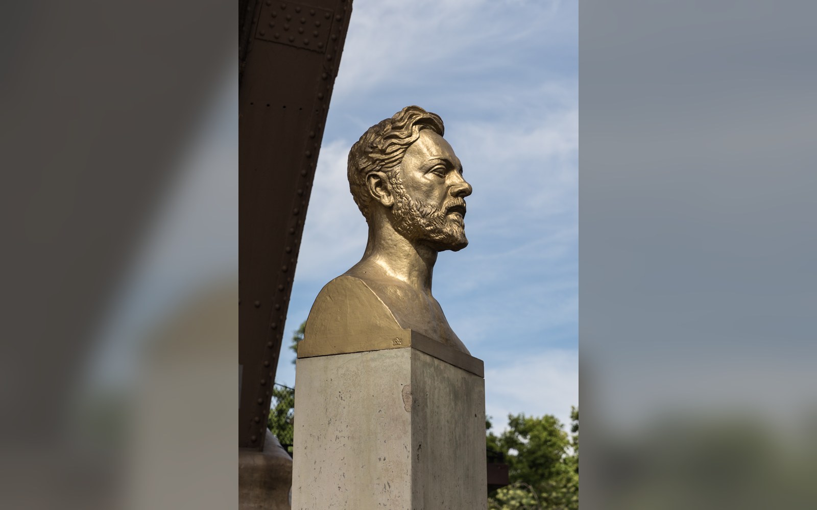 The gilded bust of Gustave Eiffel beneath the tower.